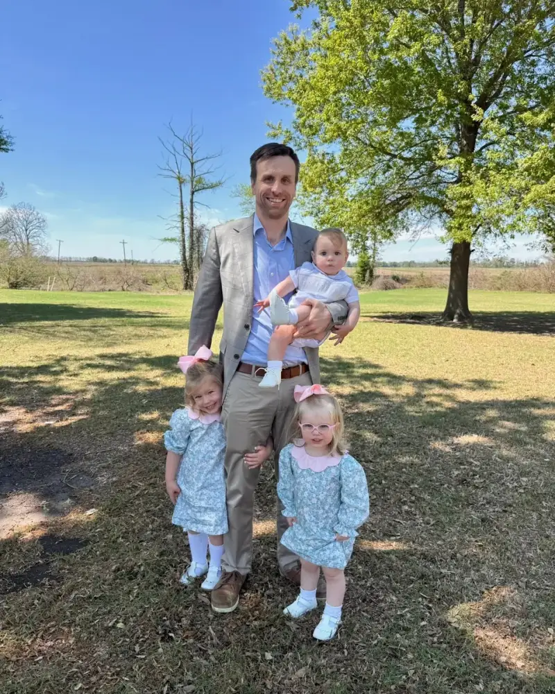 Mark Enis with his three children in a green Mississippi Delta field
