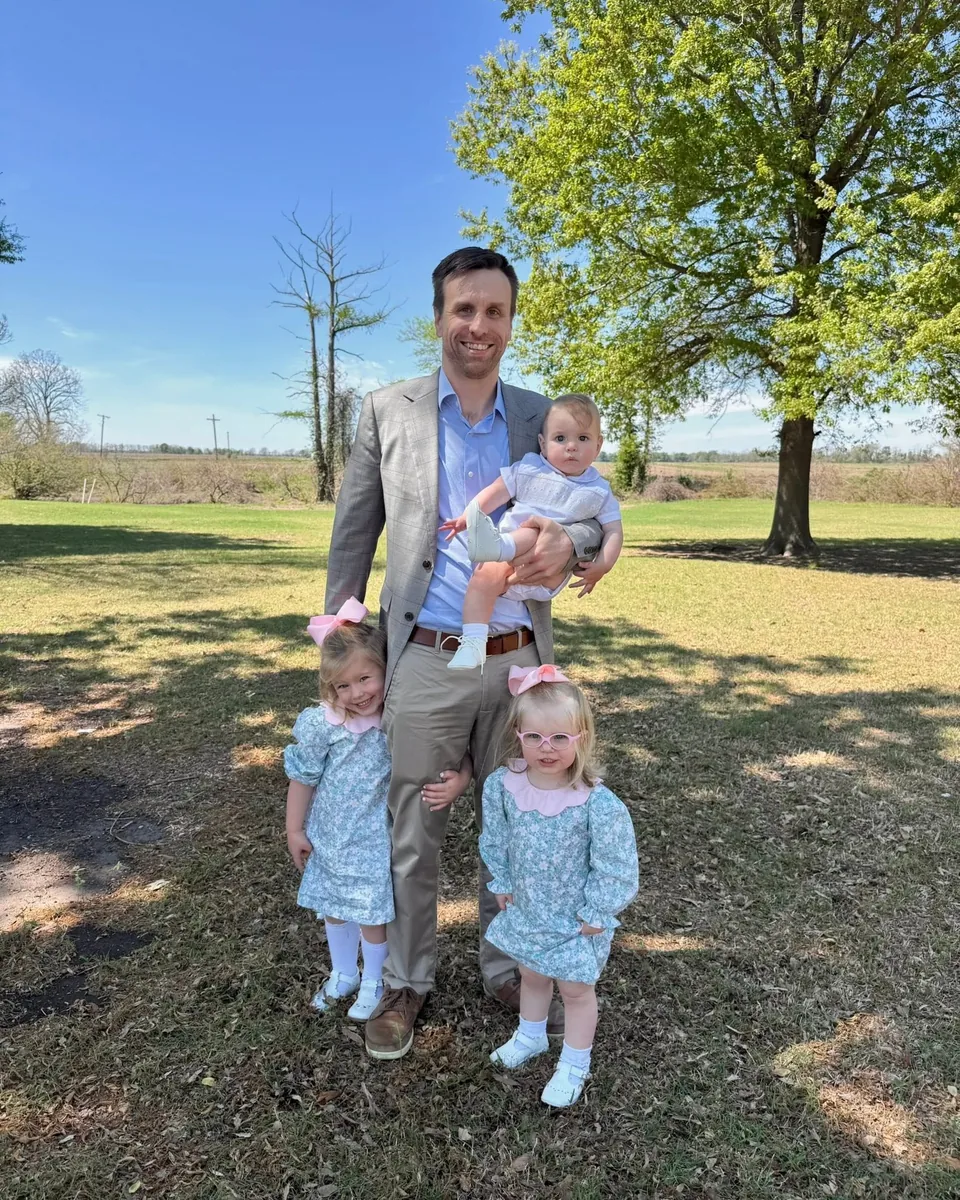 Mark Enis with his children in a green Mississippi Delta field